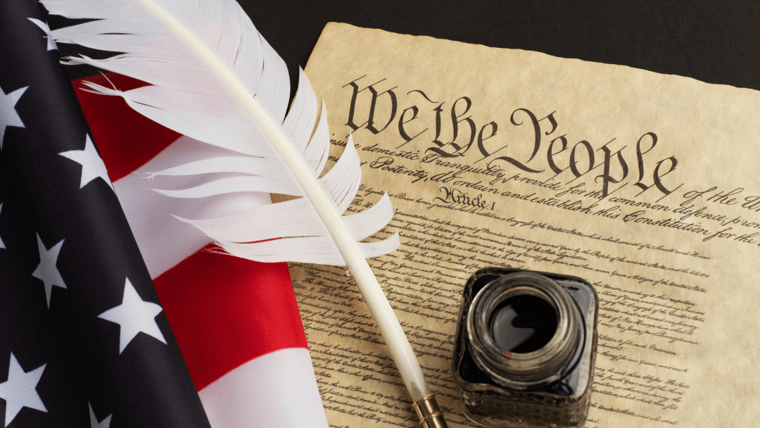 A U.S. Constitution document with a quill, ink bottle, and American flag, symbolizing the founding principles supported by FFROA.